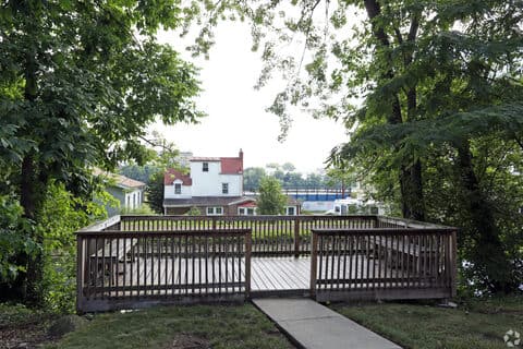 Wooden residents' deck at Canal House Apartments overlooking the canal and the far bank