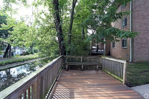 Canal-side boardwalk and bench seating along the water at Canal House Apartments