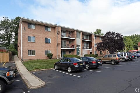 Three-storey brick apartment building at Canal House with mature landscaping and resident parking